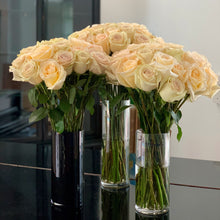 3 dozen Cream color roses with hints of purple and orange.